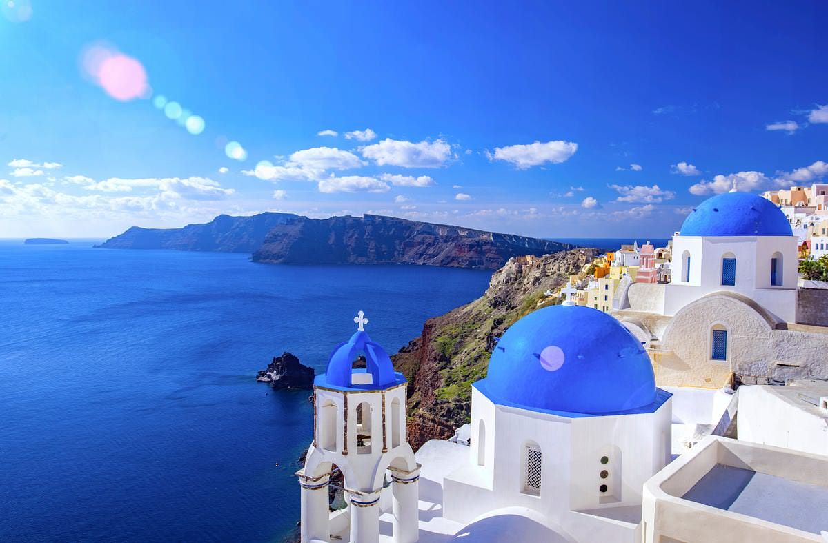 Whitewashed clifftop village overlooking the sea in Santorini, Greece